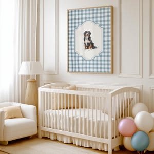 A cozy nursery with a white crib, a white chair, and a framed picture of a dog on the wall.