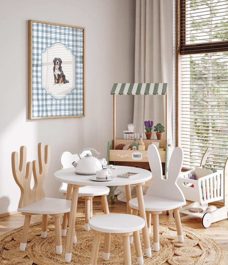 A cozy and charming children's playroom with a table, chairs, and a toy tea set, featuring a framed picture of a dog on the wall.