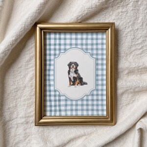 a framed picture of a dog sitting on a checkered background.