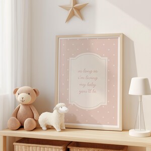 a shelf with a framed picture, a teddy bear, and a lamp, all arranged in a cozy and inviting setting.