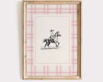 May include: Framed equestrian print featuring a black and white illustration of a person riding a horse. The print is set against a cream background with a pink plaid border and a gold-colored frame. The text "PENNY LETTER STUDIO" is at the bottom.