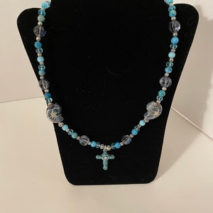 Handmade - Blue, silver, and shell beaded necklace with a blue cross charm, 28” long, High opera style