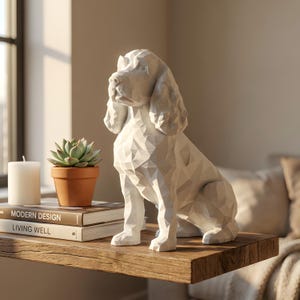 May include: A white, geometric dog sculpture sits on a wooden shelf. The dog has a detailed, angular design. Beside the sculpture is a small potted succulent, a white candle, and two books with the titles "Modern Design" and "Living Well".