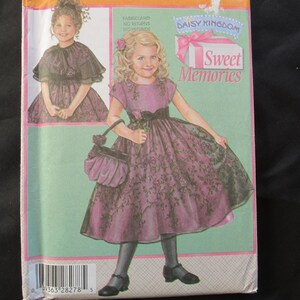 May include: Simplicity sewing pattern 4448 for a girl's dress. The pattern features a drawing of a girl in a pink dress with black lace overlay, holding a purse. The text "Sweet Memories" is also visible.