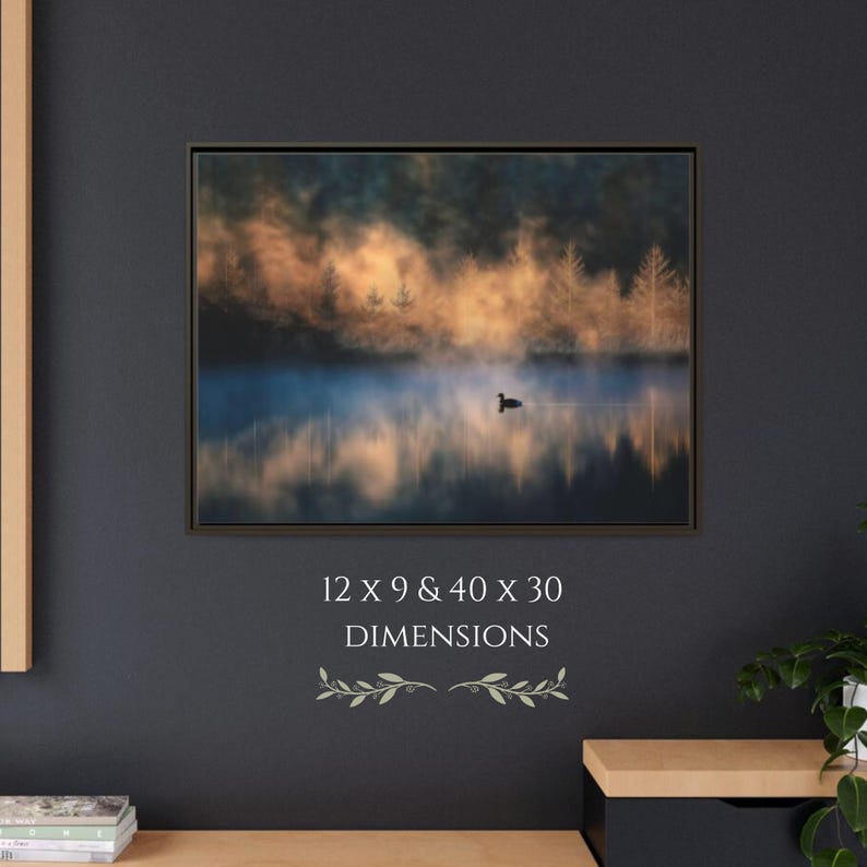 May include: Framed landscape art print featuring a serene lake scene with a single bird. The artwork displays a misty atmosphere with golden and blue hues, and the dimensions are 12 x 9 inches and 40 x 30 inches.