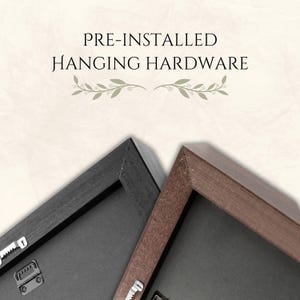 May include: Close-up of two framed canvases with pre-installed hanging hardware. One frame is black, the other is brown. The text "PRE-INSTALLED HANGING HARDWARE" is at the top of the image.