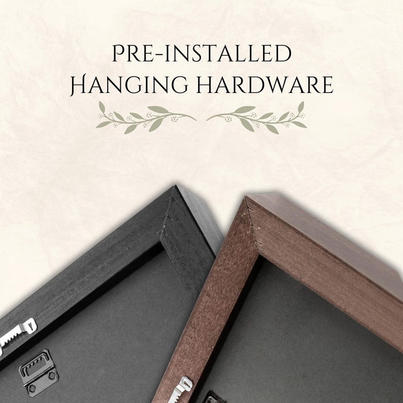 May include: Close-up of two framed canvases with pre-installed hanging hardware. One frame is black, the other is brown. The text "PRE-INSTALLED HANGING HARDWARE" is at the top of the image.