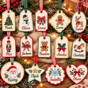 May include: A collection of thirteen embroidered Christmas ornaments in various shapes, each featuring a unique holiday motif and a personalized name. The ornaments include designs like a snowman, gingerbread man, reindeer, nutcracker, and Santa.