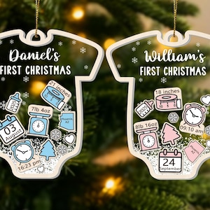May include: Two baby onesie-shaped Christmas ornaments. One reads "Daniel's FIRST CHRISTMAS" with birth details: 21 inches, 7lb 4oz, August 3, 16:23 pm. The other reads "William's FIRST CHRISTMAS" with birth details: 18 inches, 8lb 16oz, September 24, 09:10 am.