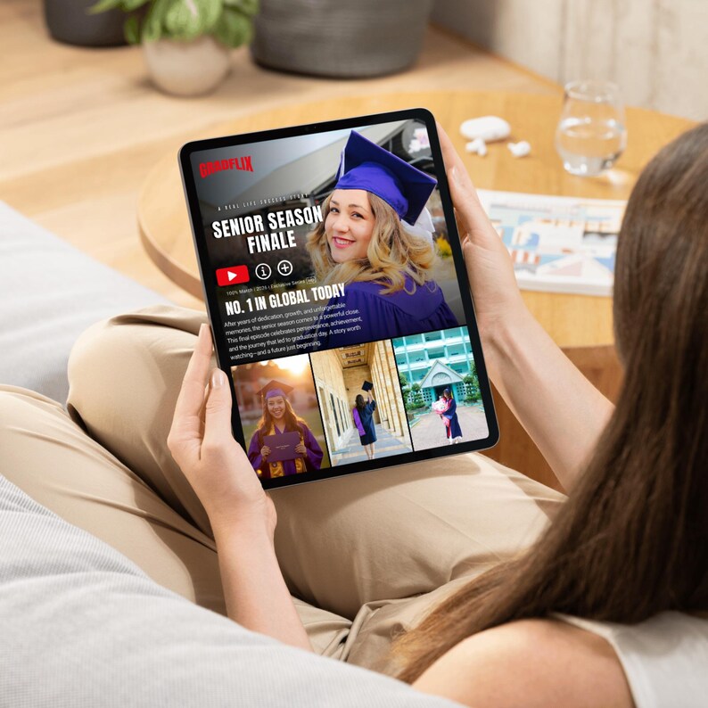 May include: A person is holding a tablet displaying a graduation-themed video. The screen shows a woman in a graduation cap with the text "SENIOR SEASON FINALE" and "NO. 1 IN GLOBAL TODAY". The tablet is black with a silver frame.