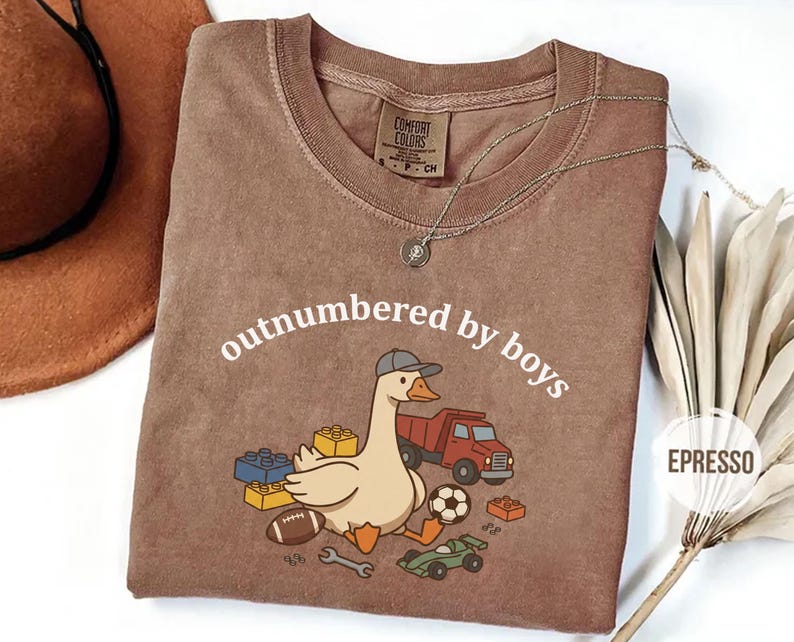 Espresso shirt with playful “outnumbered by boys” goose graphic