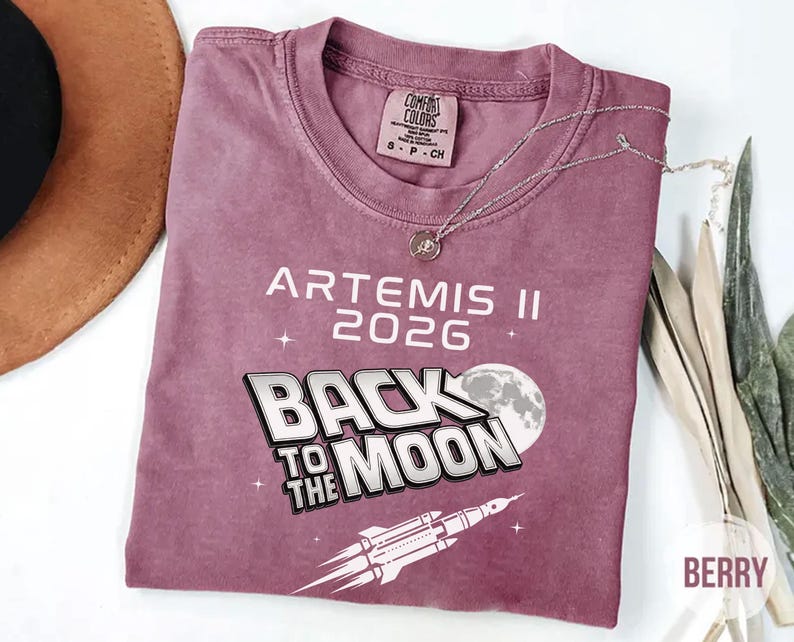 Berry Comfort Colors Artemis II 2026 shirt with white Back To The Moon graphic and rocket launch illustration