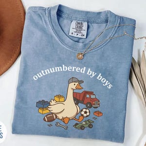Blue jean shirt featuring boy mom design with goose, truck, and blocks