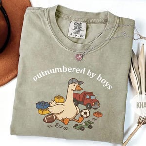 Neutral khaki shirt with boy-themed goose illustration