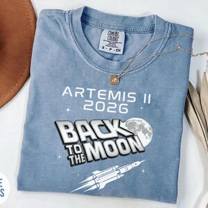 Blue Jean Comfort Colors Back To The Moon shirt featuring Artemis II 2026 moon mission design
