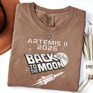 Espresso Comfort Colors Artemis II NASA shirt with Back To The Moon graphic and rocket artwork