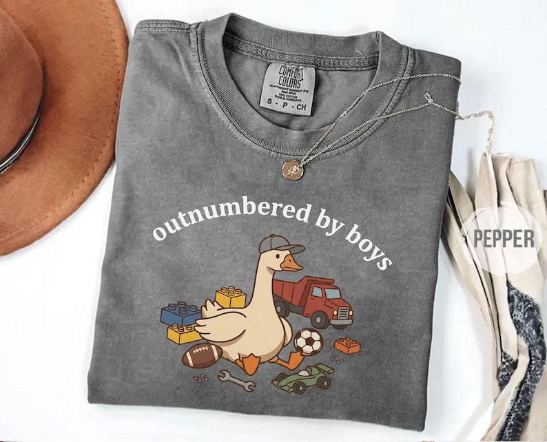 Pepper shirt with “outnumbered by boys” curved text and goose