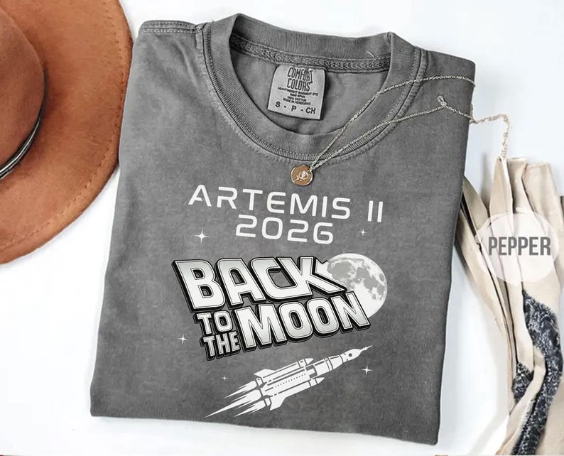 Pepper Comfort Colors Artemis II 2026 shirt featuring white and gray moon mission graphic