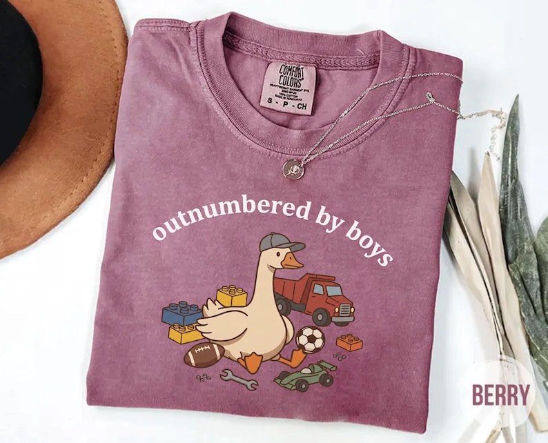 Berry Comfort Colors shirt with “outnumbered by boys” text and cute goose with toys illustration