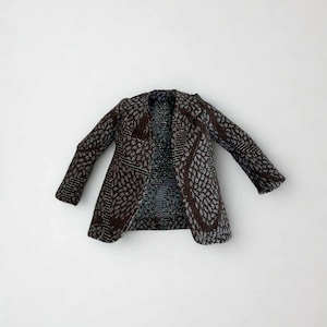 May include: A long-sleeved jacket featuring a dark brown and light blue textured pattern. The garment has a notched lapel collar, a straight hemline, and a structured silhouette with a visible weave throughout the fabric of the entire piece.