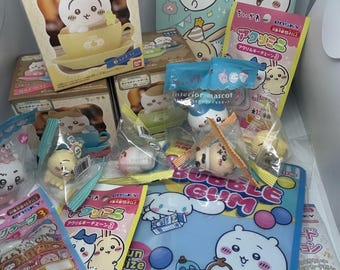 May include: A collection of Chikawa character merchandise, including boxes, keychains, and a Bubble Gum folder. The items feature cartoon characters in various poses and settings, with pastel colors and Japanese text.