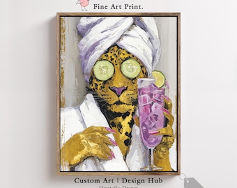 May include: A framed art print depicting a leopard wearing a white robe and a towel, with cucumber slices on its eyes, holding a purple cocktail. The artwork includes the text "Fine Art Print" and "Custom Art | Design Hub Digitally Drawn".