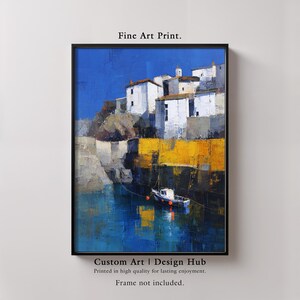 May include: A framed fine art print depicting a coastal scene. White buildings with dark roofs sit atop a cliff, overlooking a harbor with a small boat. The water reflects the blue sky and yellow accents. Text reads "Fine Art Print" and "Custom Art | Design Hub."