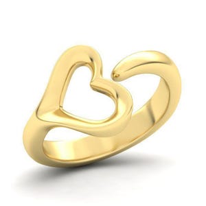 May include: A polished gold ring featuring an open, stylized heart design. The band is smooth and continuous, curving upward to form the heart shape with a small gap at the top right, showcasing a bright, reflective metallic finish throughout.