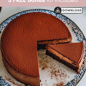 May include: A chocolate cake with a slice removed, dusted with cocoa powder, sits on a decorative plate with a blue and white pattern. The cake has a rich, dark brown color and a creamy filling. Text reads "3 FREE Bonus Kit Included" and "DOWNLOAD".