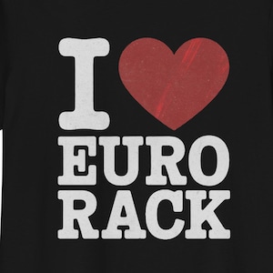 May include: Black t-shirt with the text "I ❤️ EURO RACK" in white and a red heart. The shirt is a crew neck style and appears to be made of a soft material. The graphic is centered on the front of the shirt.