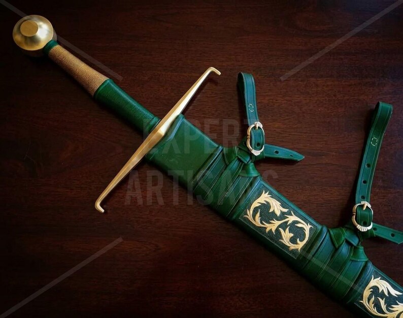 May include: A sword with a gold-colored pommel and crossguard, featuring a green leather-wrapped grip and a matching green scabbard. The scabbard is adorned with gold-colored filigree patterns and includes integrated leather straps with buckles.