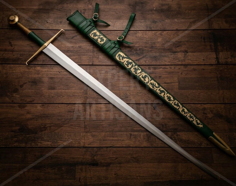 May include: A longsword with a silver-toned blade, a gold-toned crossguard, and a green grip. Beside it lies a matching green scabbard featuring intricate gold-toned floral scrollwork patterns and leather straps with gold-toned buckles.