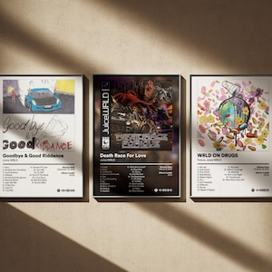 May include: Three framed album art prints. The first features a blue car graphic and the text "Goodbye & Good Riddance." The second has a dark image with the text "Death Race For Love." The third displays a colorful design with the text "WRLD ON DRUGS."