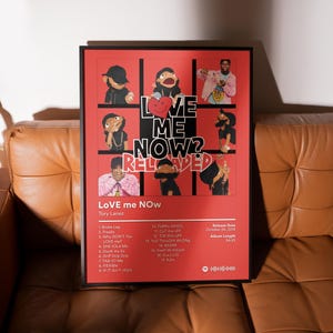 May include: A framed red poster featuring the album art for "LOVE me NOW? RELOADED" by Tory Lanez. The artwork includes puppet-like figures and the album title in large white letters. The poster also lists the tracklist, release date, and album length.