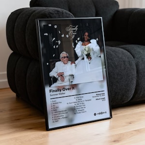 May include: Framed album art for Summer Walker's "Finally Over It." The image features a photo of a bride and an older man in a white suit. The album title and tracklist are displayed in white text on a black background. The release date is November 14, 2025.