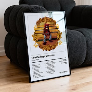 May include: Framed poster featuring the album art for Kanye West's "The College Dropout." The artwork depicts a bear in a red jacket and blue jeans. The poster includes the album's tracklist, release date, and album length.