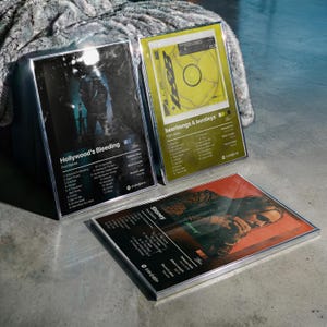 May include: Three framed music album posters featuring Post Malone's Hollywood's Bleeding, beerbongs & bentleys, and Stoney. Each print displays the album title, tracklist, release date, album length, record label, and a Spotify-style code.
