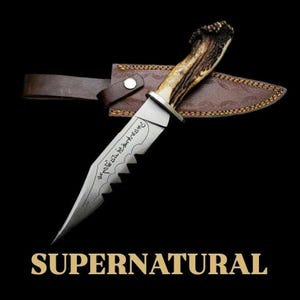 May include: A hunting knife with a serrated blade and a handle made of antler. The knife is in a brown leather sheath with a snap closure. The word "SUPERNATURAL" is displayed in gold lettering at the bottom of the image.