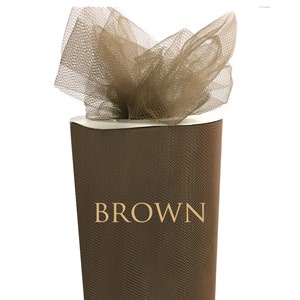 May include: A roll of brown tulle fabric. The tulle is a fine, sheer mesh fabric often used for crafts and decorations.