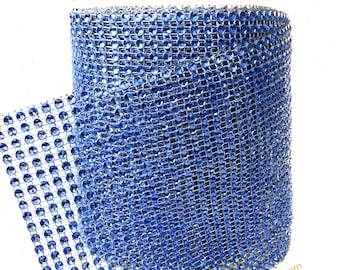 May include: A roll of blue diamond mesh ribbon. The ribbon is made of small, clear rhinestones that are set in a silver mesh backing. The ribbon is perfect for adding a touch of sparkle to any craft project.