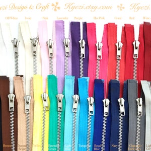May include: Assortment of 20 zipper tapes in various colors, including white, off-white, ivory, pink, lavender, purple, hot pink, coral, red, wine, black, brown, beige, yellow, emerald green, light blue, turquoise, royal blue, navy, charcoal, dark grey, and light grey. Each zipper tape has a silver metal slider.