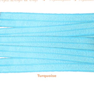 May include: Turquoise elastic cord, a type of stretch cord, is shown in a close-up image. The cord is arranged in parallel lines, showcasing its texture and color.