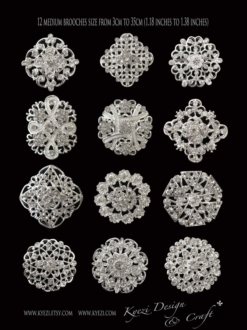 May include: Twelve silver brooches with rhinestone embellishments. The brooches are in various shapes and sizes, ranging from 3 to 3.5 cm.