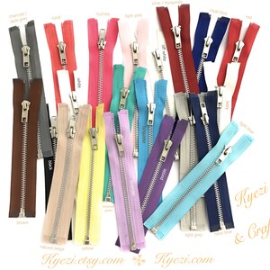 May include: Assortment of 20 zipper closures in various colors, including charcoal, dark grey, cool, fuchsia, light pink, wine, burgundy, royal blue, red, white, black, brown, off white, purple, ivory, light blue, light grey, navy blue, natural beige, and yellow.  Kyezi Design & Craft.