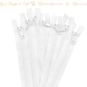 May include: A bundle of 6 white zipper closures with metal sliders. The zippers are approximately 5 inches long.