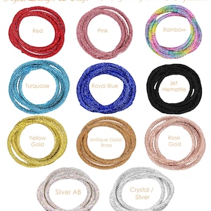 Könnte beinhalten: Eine Sammlung von aufgerollten Strassfäden in verschiedenen Farben, darunter Rot, Pink, Regenbogen, Türkis, Königsblau, Schwarz, Gelbgold, Antikgold/Messing, Roségold, Silber AB und Kristall/Silber. Der Text "Kyezi Design & Craft" und "Kyezi.etsy.com" sind sichtbar.