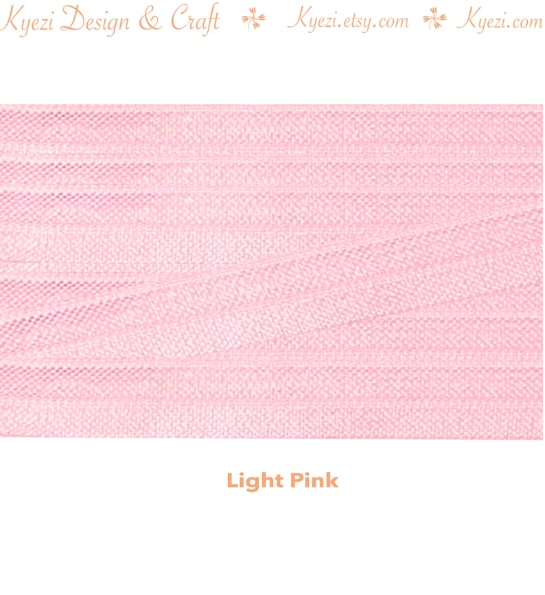 May include: Light pink tulle fabric with a fine, woven texture. The fabric is soft and delicate, and it has a slightly shimmery finish.