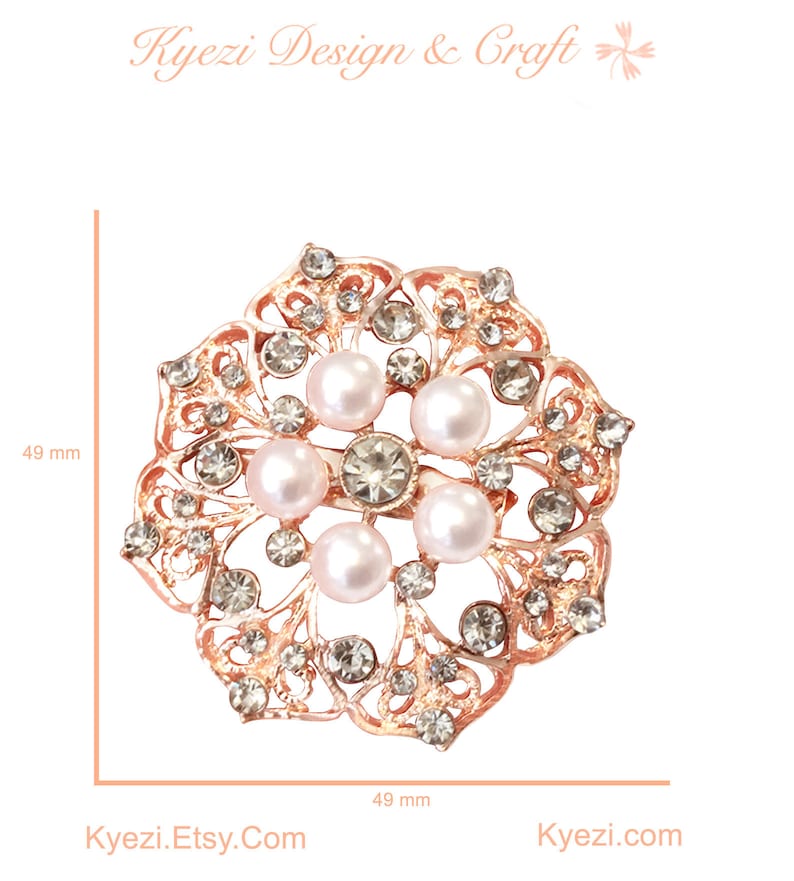 May include: A rose gold brooch with a floral design, featuring faux pearls and clear crystals. The brooch is approximately 49 mm in diameter. The text "Kyezi Design & Craft" and "Kyezi.Etsy.Com" are visible.