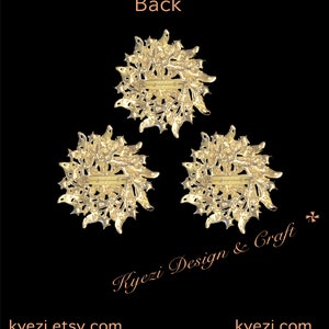 May include: Three gold brooches with a floral design are shown against a black background. Each brooch has a pin closure on the back. The word "Back" is at the top, and the Etsy shop name is at the bottom of the image.