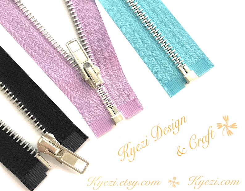 Peut inclure: Gros plan sur plusieurs fermetures &eacute;clair noires, lavande et bleu clair. Chaque fermeture &eacute;clair a un curseur et des dents en m&eacute;tal argent&eacute;. L'image comprend le texte "Kyezi Design & Craft" et "kyezi.etsy.com".
